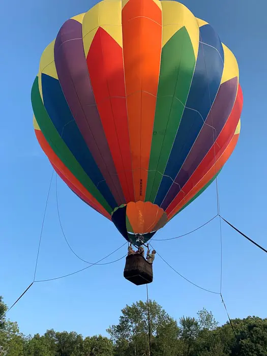 A colorful hot air balloon flying in the sky.