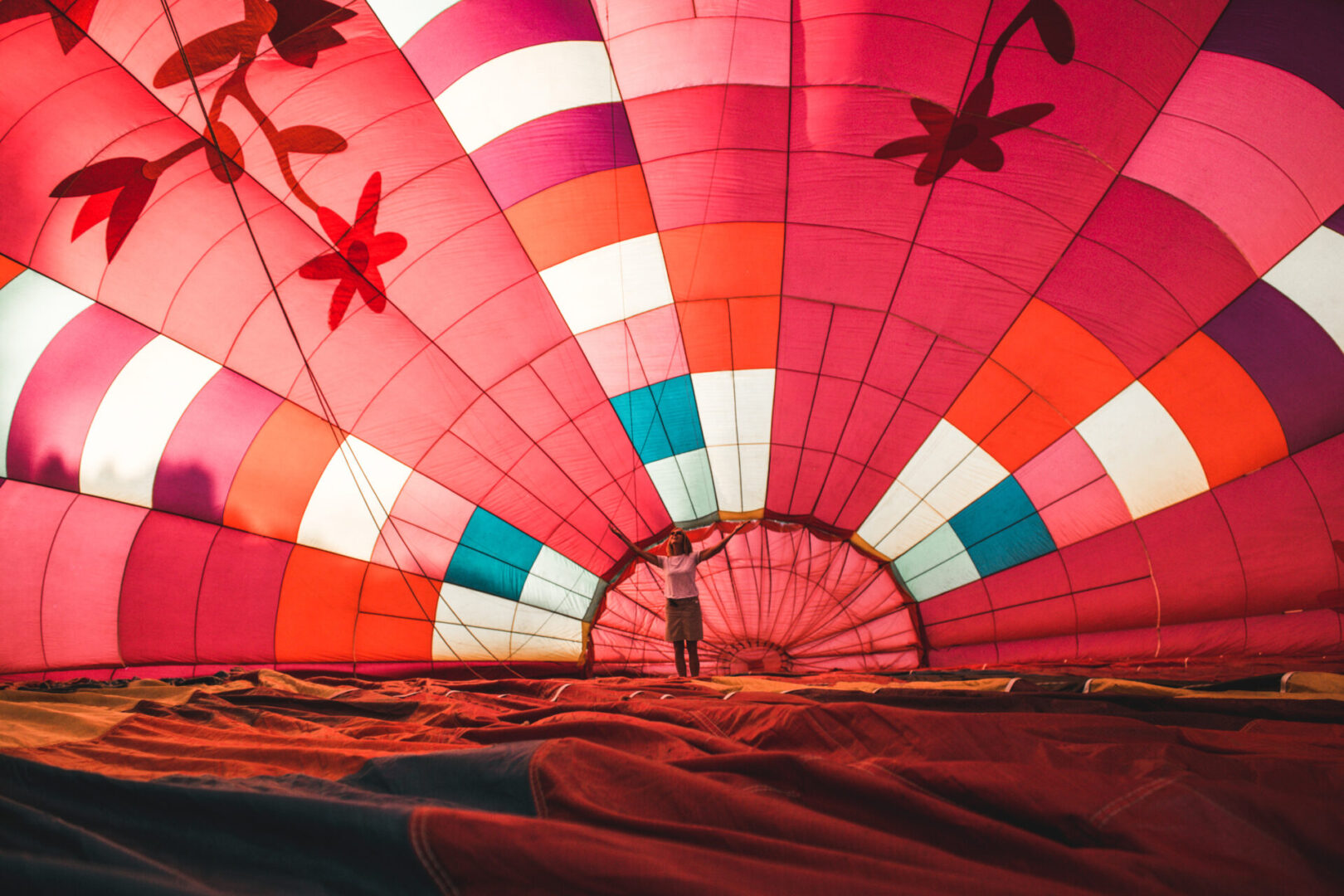 A person standing inside of a hot air balloon.