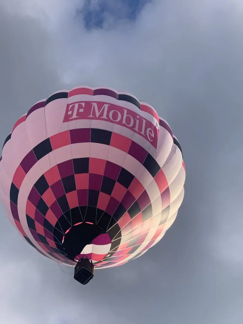 A pink and black balloon with the words " t mobile ".
